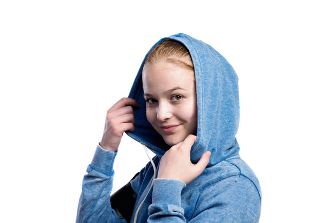 Teenage girl in blue sweatshirt. Studio shot, isolated. - Zdjęcie, obraz