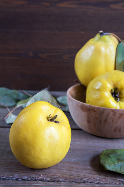 Fresh quince fruit on dark wooden table - Fotografie, Obrázek