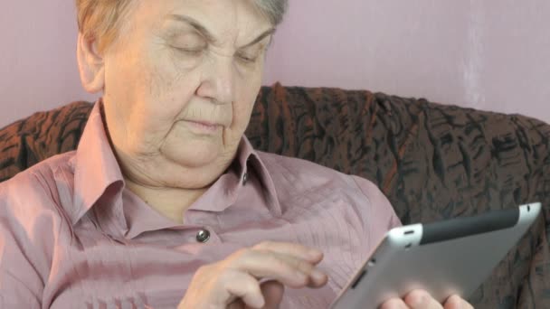 Elderly woman with digital tablet computer indoors - Metraje, vídeo