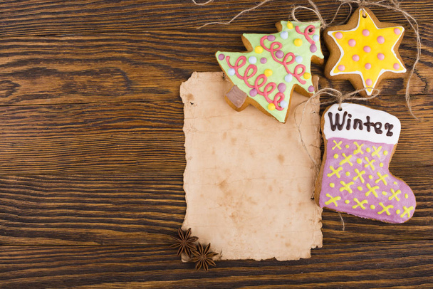 Gingerbread cookies hanging over wooden background - Photo, Image