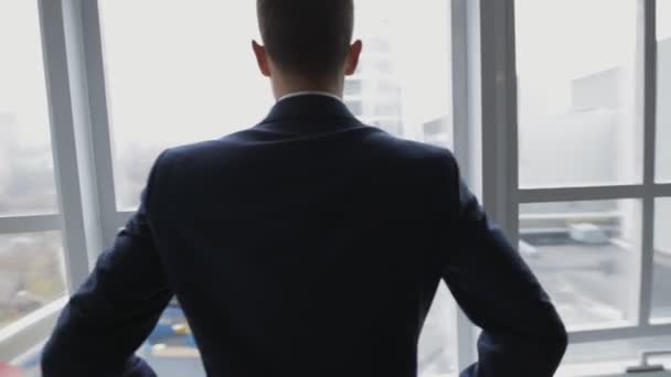 Businessman in white office thinking standing at window - Video, Çekim
