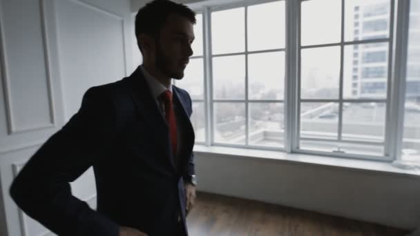 Businessman in white office waiting and thinking looking at window - Séquence, vidéo