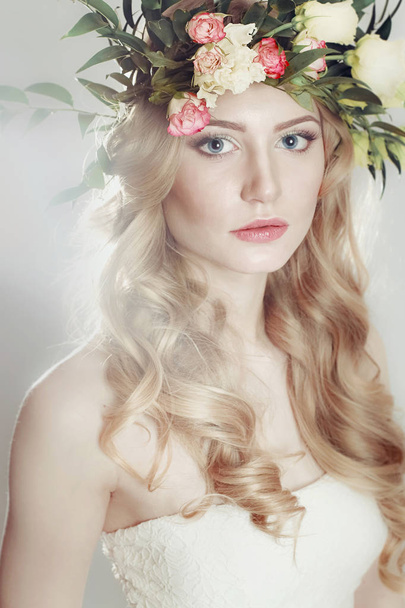 girl with a wreath of flowers on her head on white background - Φωτογραφία, εικόνα