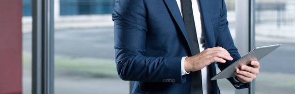 Businessman in suit using tablet - Fotó, kép