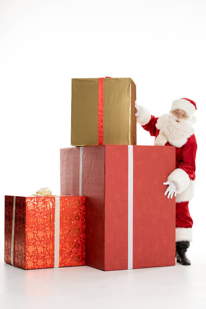 Santa Claus with pile of Christmas gifts - Zdjęcie, obraz