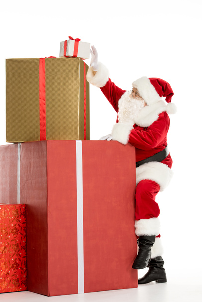 Santa Claus with pile of Christmas gifts - Fotó, kép