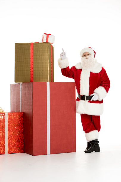 Santa Claus with pile of Christmas gifts - Foto, Imagen