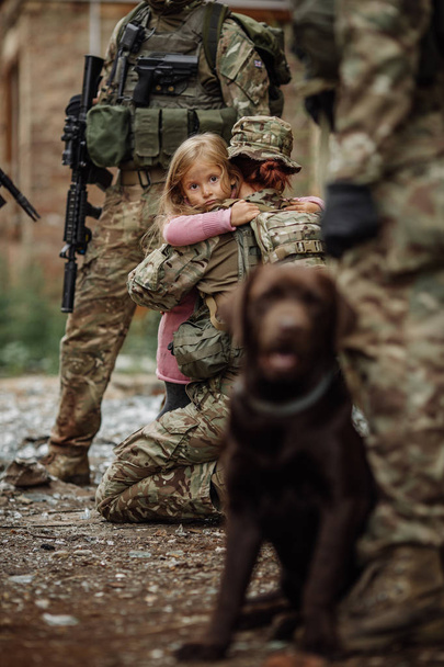 Soldier and children on battlefield background. Military and rescue operation concept. - Фото, зображення