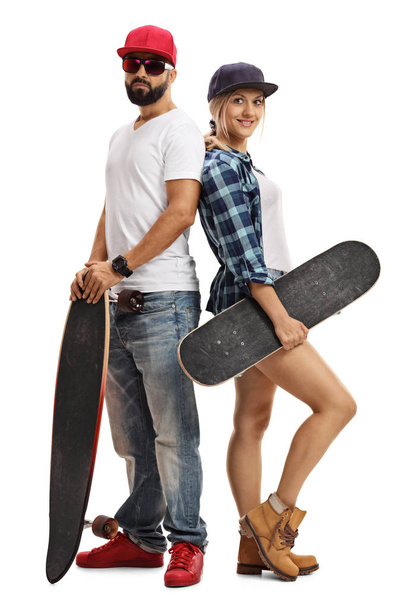 Male and female skater posing with longboard and skateboard - Фото, зображення