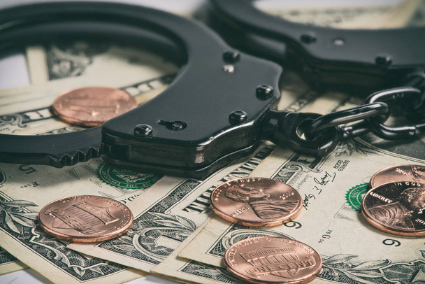 Handcuffs on money - Фото, изображение
