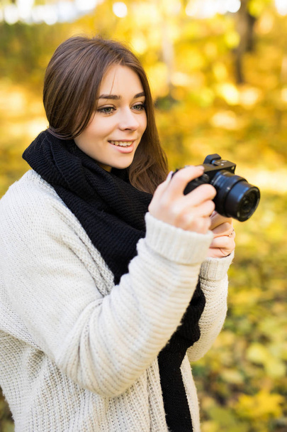 Girl take selfie photo with camera in yellow autumn park - 写真・画像