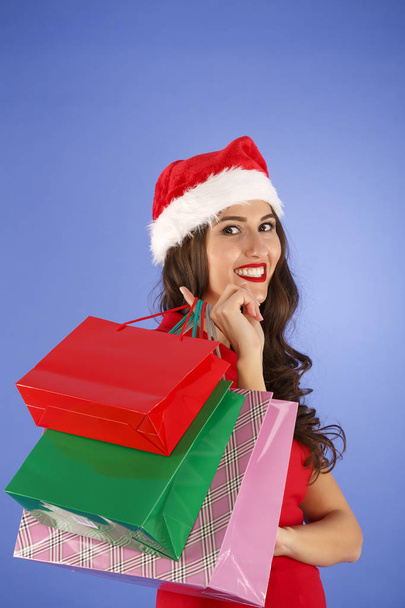 Porträt einer jungen lächelnden Frau beim Einkaufen vor Weihnachten - Foto, Bild