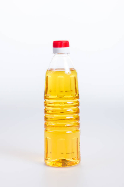 oil or oil in plastic bottle on the background. - Zdjęcie, obraz