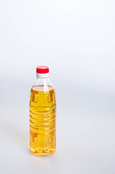 oil or oil in plastic bottle on the background. - Foto, Imagem