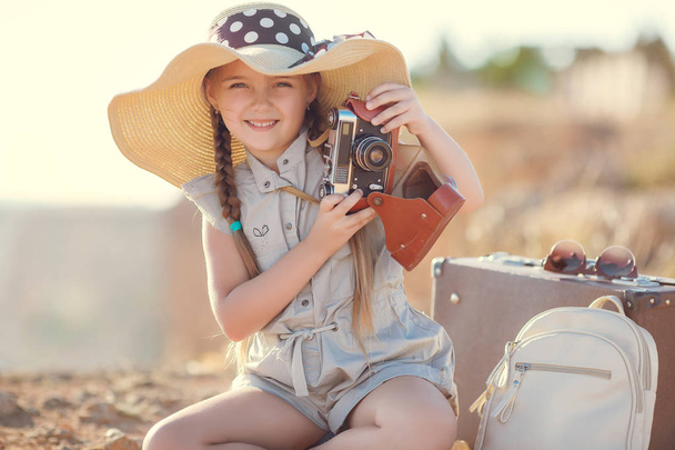 Young photographer with a big hat on a rock - Foto, imagen