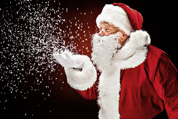 Père Noël soufflant flocons de neige
  - Photo, image