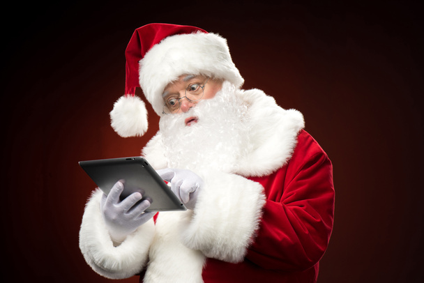 Père Noël avec tablette numérique
 - Photo, image