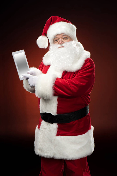 Santa Claus with digital tablet - 写真・画像