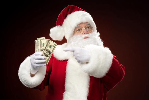 Kerstman met dollars - Foto, afbeelding