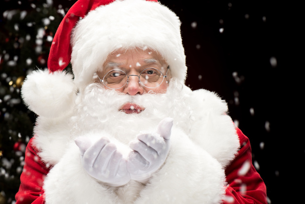 Santa Claus blowing snowflakes   - Фото, зображення