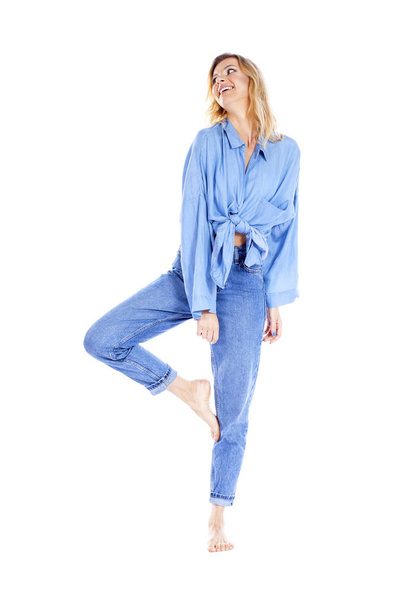 Young beautiful blonde woman in blue jeans  - Foto, Imagen