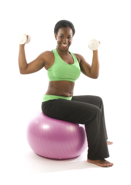 Young pretty hispanic african american woman exercising with fit ball - Foto, Imagen