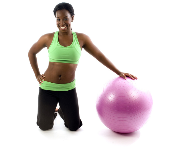 Young pretty hispanic african american woman exercising with fit ball - 写真・画像