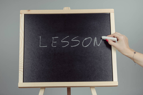 Lesson written in white chalk on a black chalkboard - Photo, Image