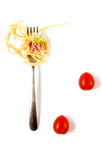 Italian pasta with tomato on fork - 写真・画像
