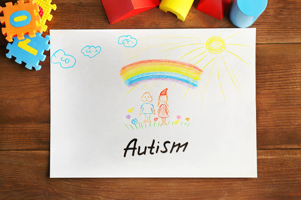 Word AUTISM written on paper and toys - Foto, Imagen