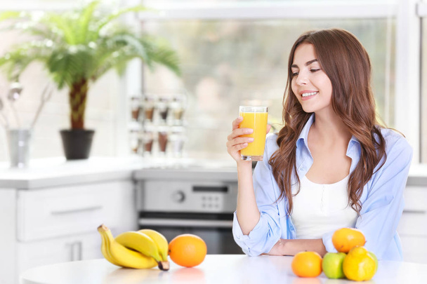 woman drinking orange juice - Фото, изображение