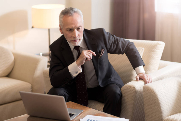 Delighted businessman sitting in front of the laptop - Foto, immagini