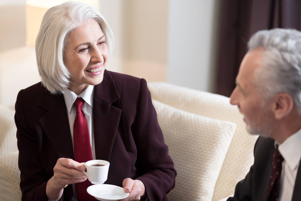 Delighted businesswoman having the conversation with her colleague - Photo, image