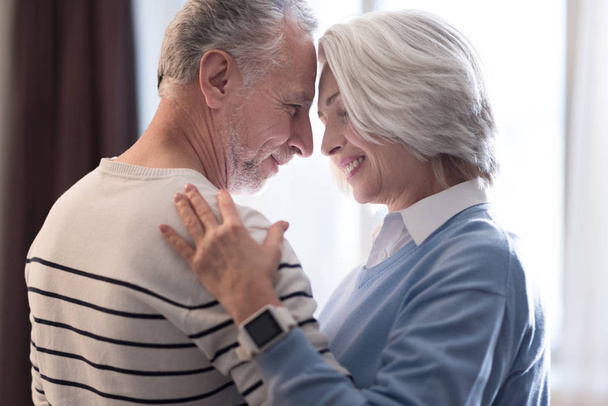 Happy aged couple dancing at home - Foto, Imagen