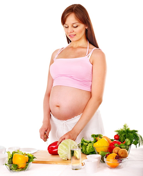 Pregnant woman preparing food . - Photo, Image