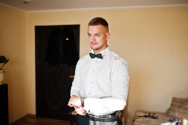 Man looking on luxury watches. Gathering of groom on wedding day - Fotó, kép
