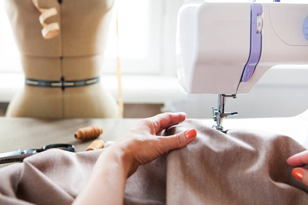 Woman tailor working on sewing machine. Hands. close up.  Tailor - Fotó, kép