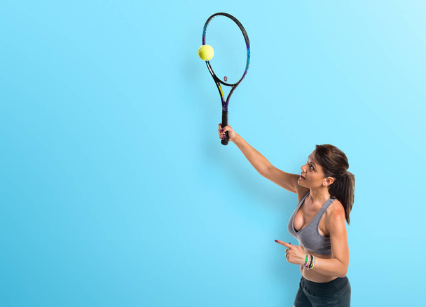 Pretty woman playing tennis - Фото, изображение