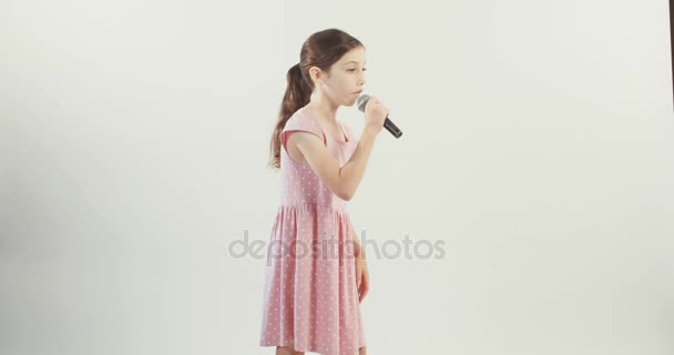 Little girl singing with microphone - Footage, Video