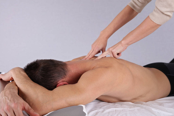 Man having sport massage. Acupressure, Chiropractic, osteopathy, concept . - Fotó, kép