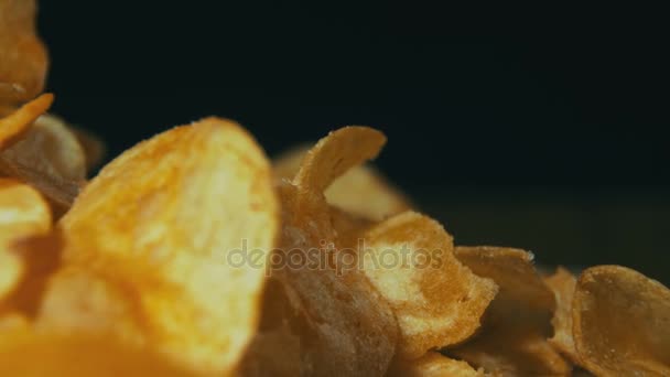 Potato Chips Rotating On Black Background - Video