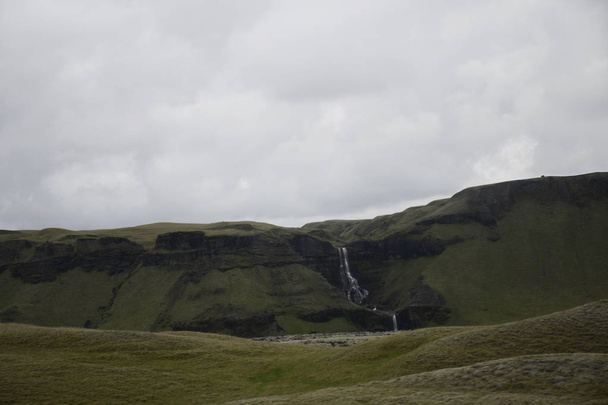 Epic Landscape in Iceland with green grass and mountain waterfall - Photo, image