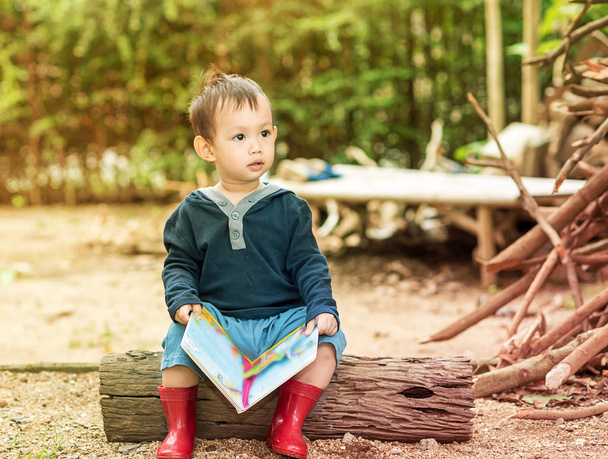 Asian baby boy  reading tale book ,The  Boy wear red boot sittin - Foto, Imagem