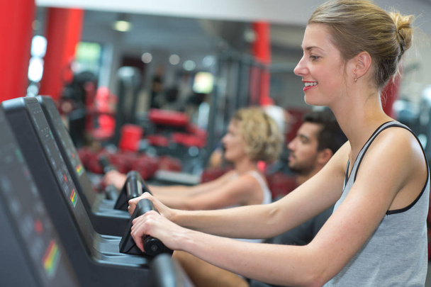 smiling woman running on a treadmill - Photo, image
