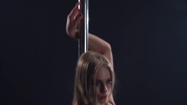 Pole dance. View of girl moves her body excitingly - 映像、動画