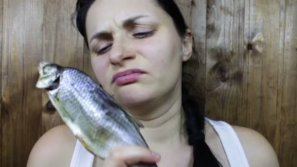 Girl holding a stinky fish - Footage, Video