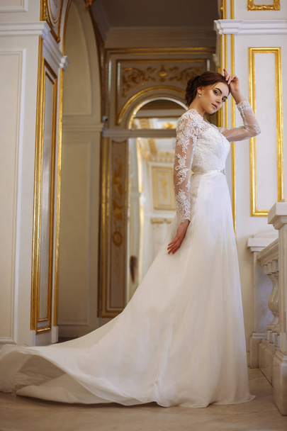 beautiful young woman bride in luxury wedding dress in interior - Фото, изображение