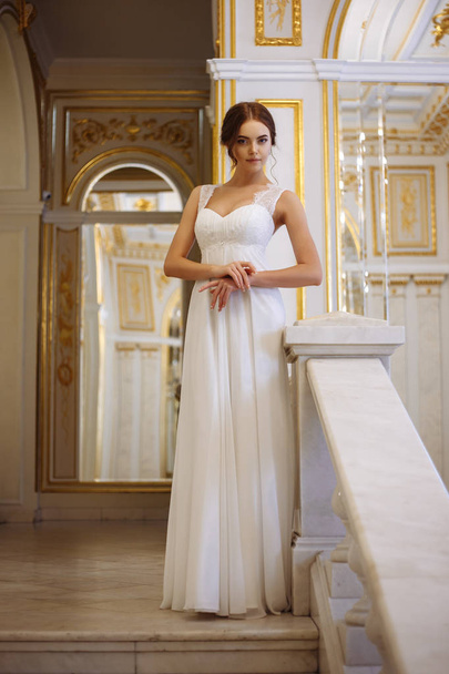 beautiful young woman bride in luxury wedding dress in interior - Fotó, kép