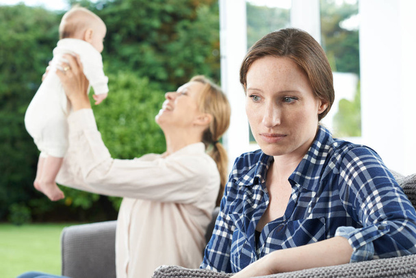 Sad Woman Jealous Of Friend With Young Baby - Foto, Imagen