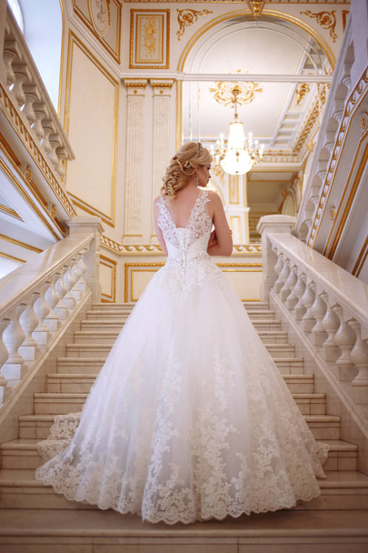 beautiful young woman bride in luxury wedding dress in interior - Photo, Image